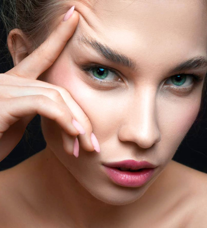 stock image of model lifting eyebrows with finger