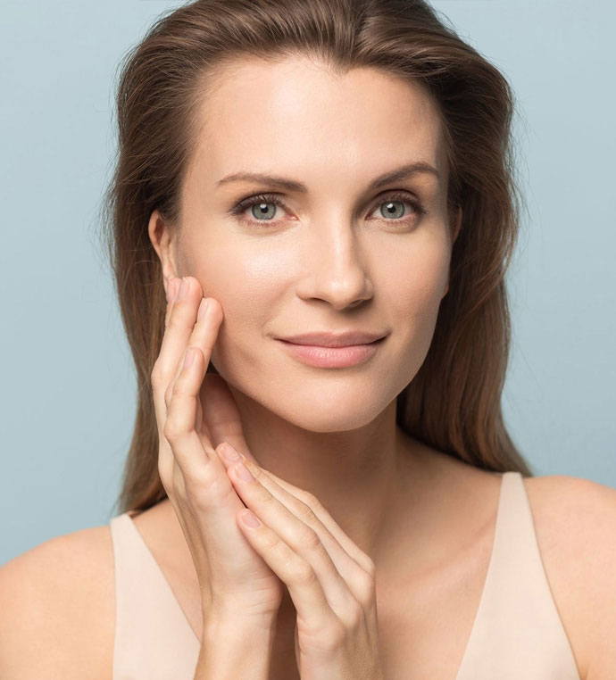 stock image of model smiling having her hands under chin